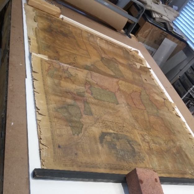 Image of an antique map before restoration