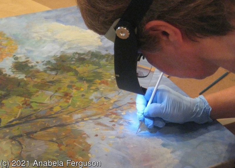 Anabela at work in her studio restoring a painting
